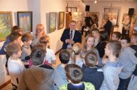 Grupa osób na sali w muzeum podczas wernisażu